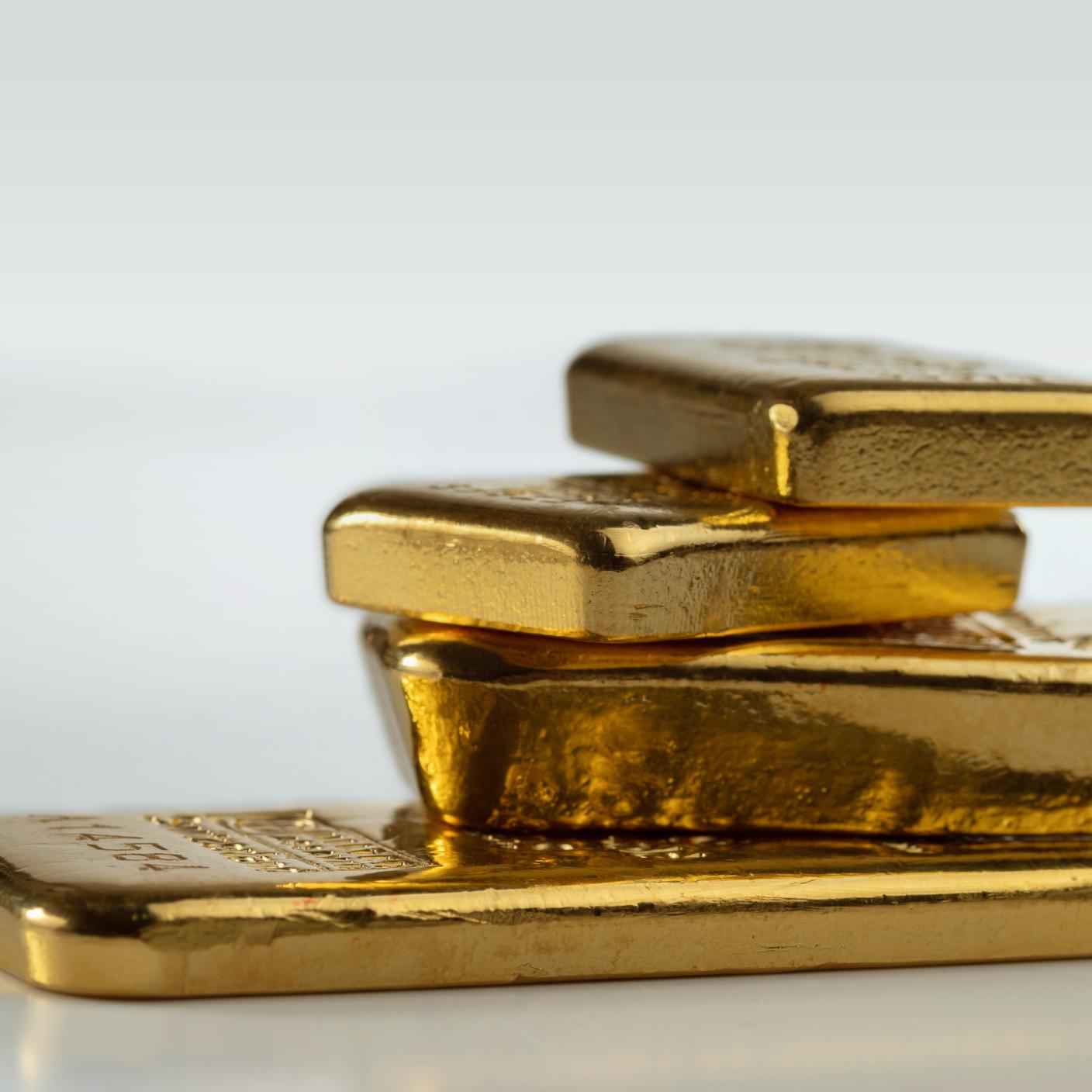 our gold bars of various weights on a light background. 
