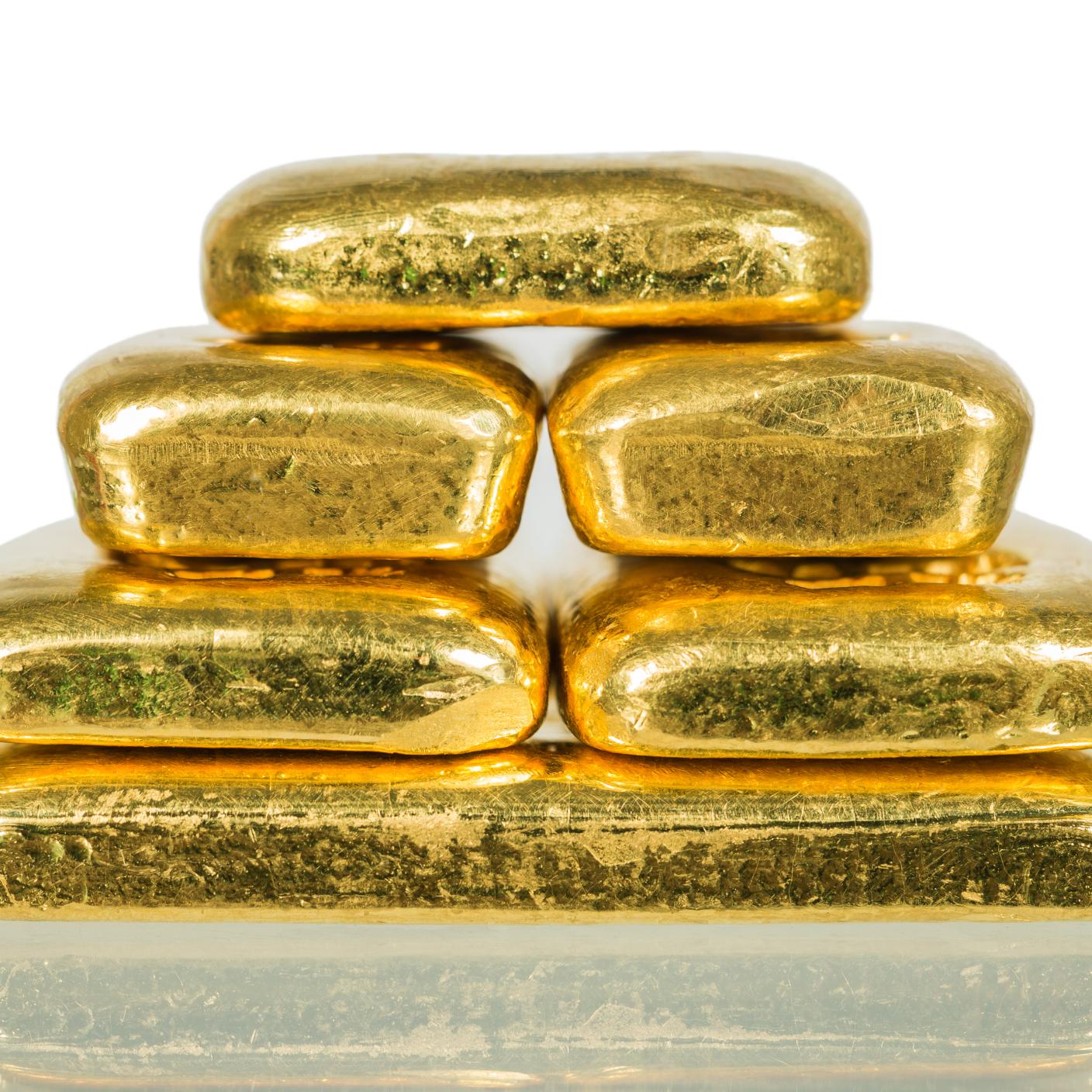 Pile of gold bullion with shadow isolated on white.