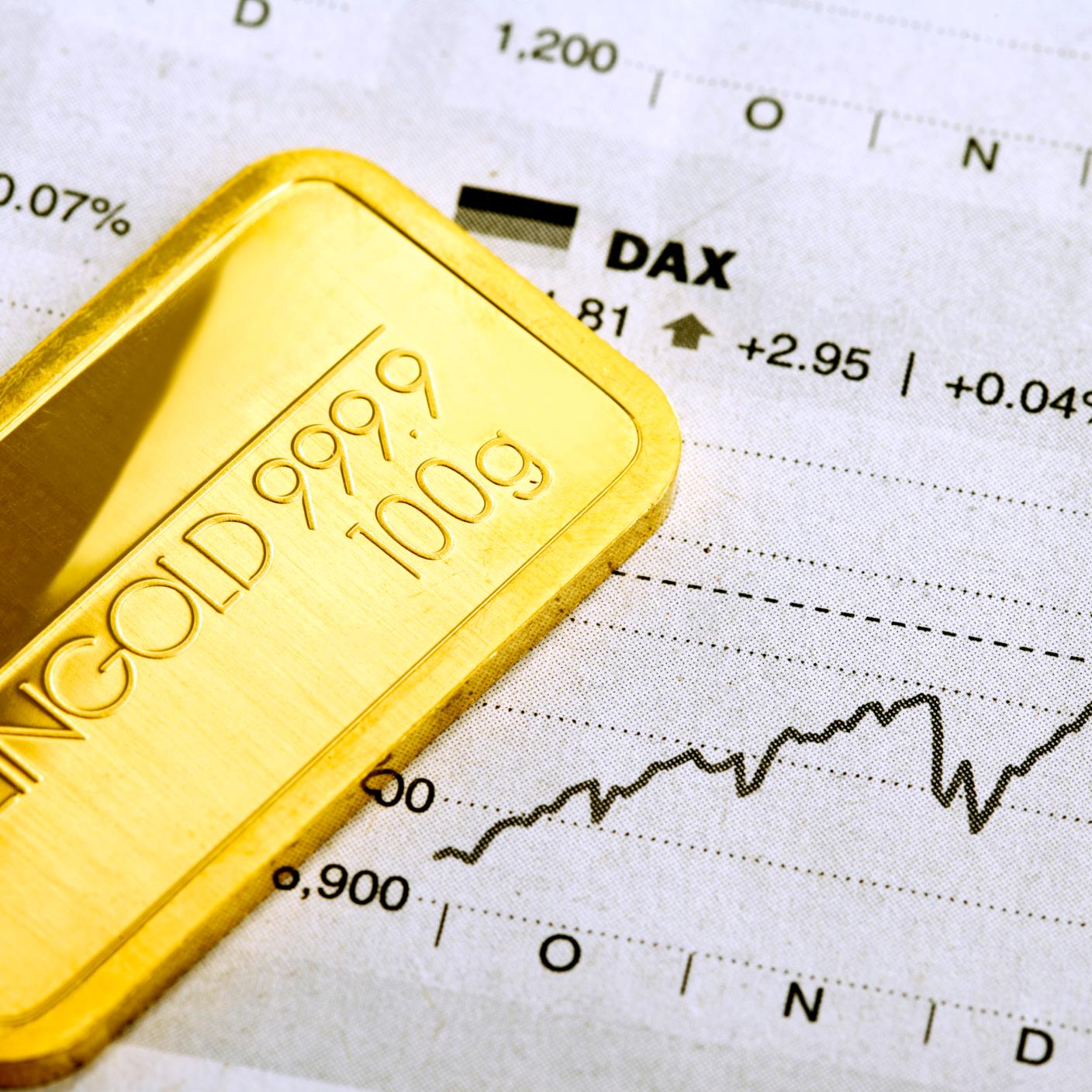 Gold bar over paper with stats.