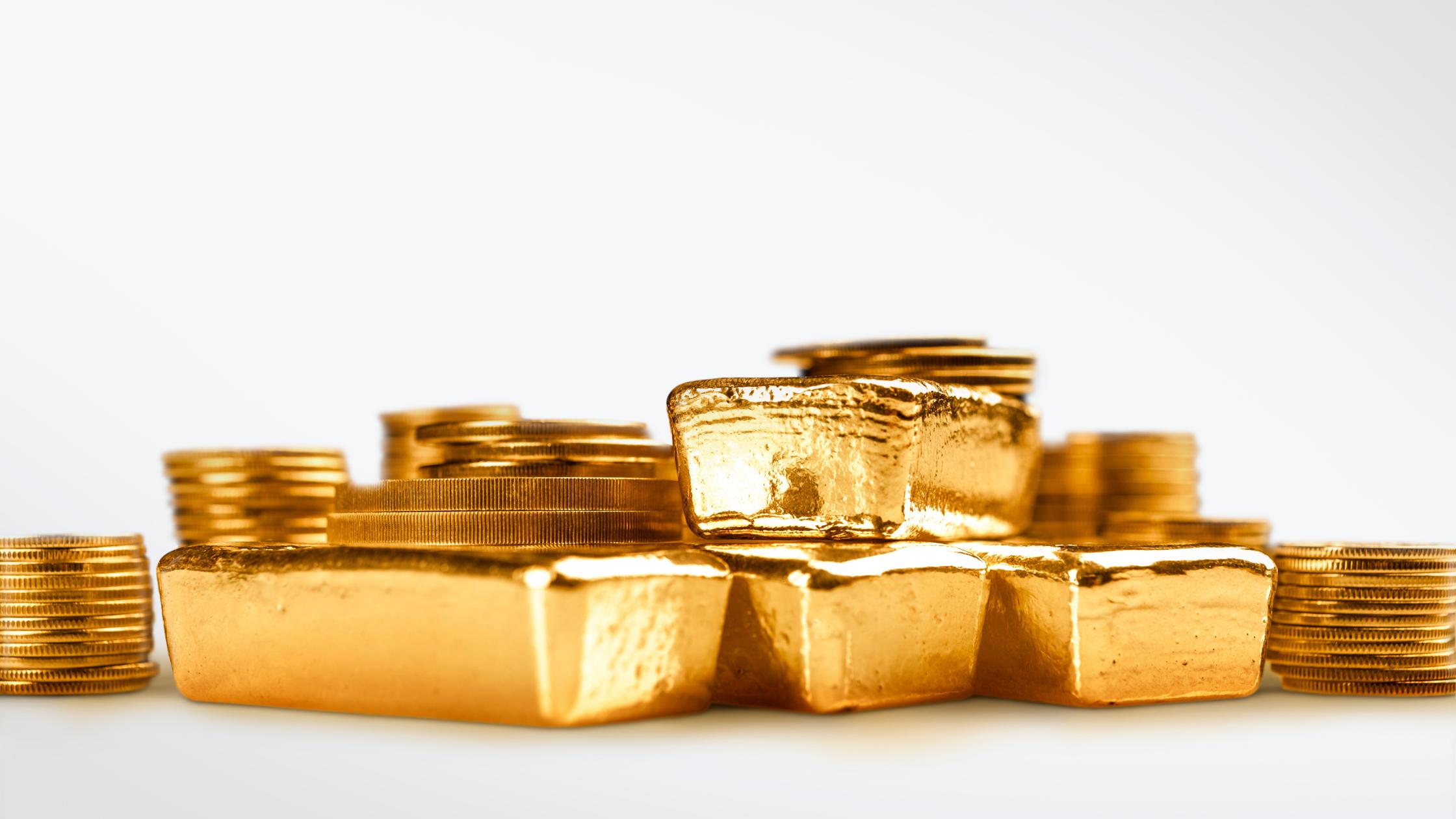 Gold bars and stack of gold coins macro. Rows of coins and gold ingots for finance and banking concept. 
